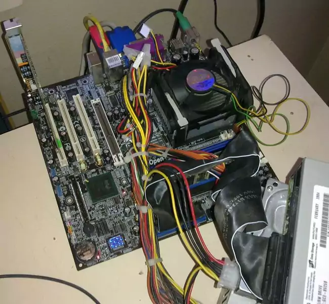 A motherboard hooked up and running on a table.
